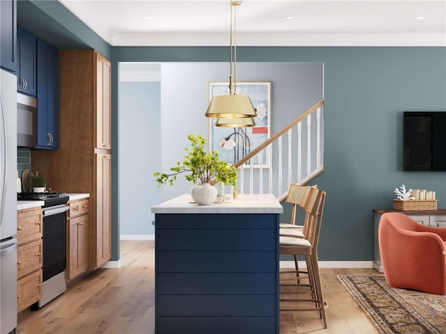 705 Bower St, Cranberry Twp, PA 16066 - kitchen with stainless steel appliances, light wood-style floors, light countertops, decorative light fixtures, and blue cabinets