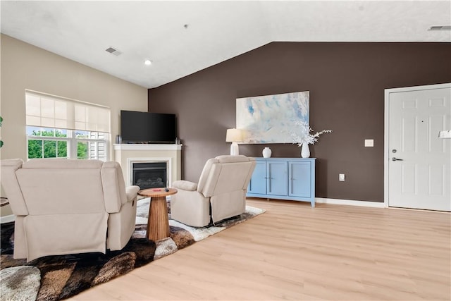 219 Stockton Rdg, Cranberry Twp, PA 16066 - living room with light wood finished floors, vaulted ceiling, a glass covered fireplace, and recessed lighting