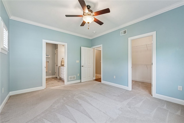 416 Willow Ct, Allegheny Twp, PA 15613 - unfurnished bedroom featuring crown molding, light colored carpet, a spacious closet, a ceiling fan, and connected bathroom