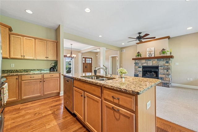 416 Willow Ct, Allegheny Twp, PA 15613 - kitchen with dishwasher, ceiling fan, a fireplace, light stone countertops, and a center island with sink