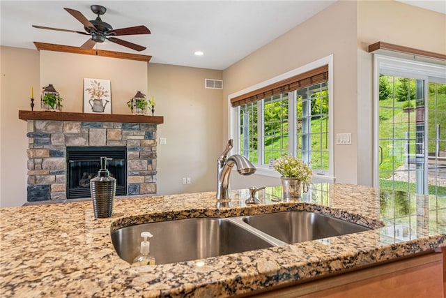 416 Willow Ct, Allegheny Twp, PA 15613 - kitchen with light stone countertops, healthy amount of natural light, ceiling fan, a stone fireplace, and recessed lighting