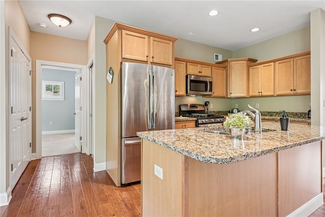 416 Willow Ct, Allegheny Twp, PA 15613 - kitchen with appliances with stainless steel finishes, light stone counters, wood-type flooring, recessed lighting, and a kitchen island with sink