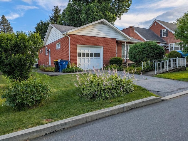 308 E Highland Ave, Ebensburg, PA 15931 - view of front facade with an attached garage, a front yard, brick siding, and asphalt driveway