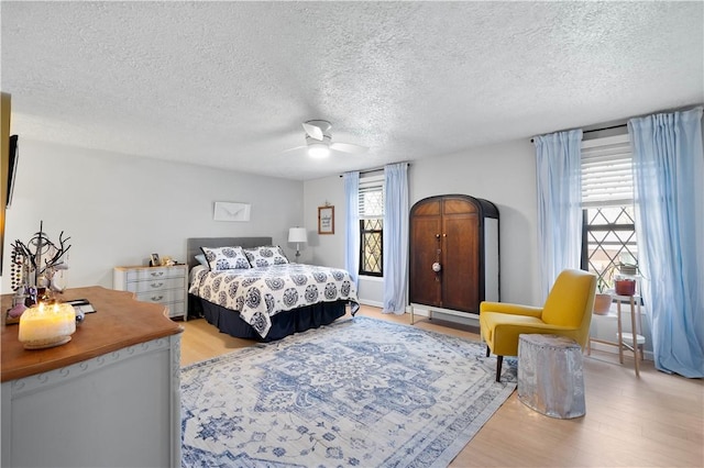 507 Sewickley Heights Dr, Aleppo, PA 15143 - bedroom featuring light wood finished floors, a textured ceiling, and ceiling fan