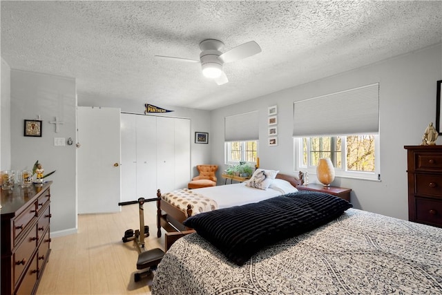 507 Sewickley Heights Dr, Aleppo, PA 15143 - bedroom with light wood-style floors, a closet, a ceiling fan, and a textured ceiling