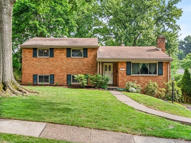 119 Abington Dr, Mt Lebanon, PA 15216 - split level home with a chimney, brick siding, and a front lawn