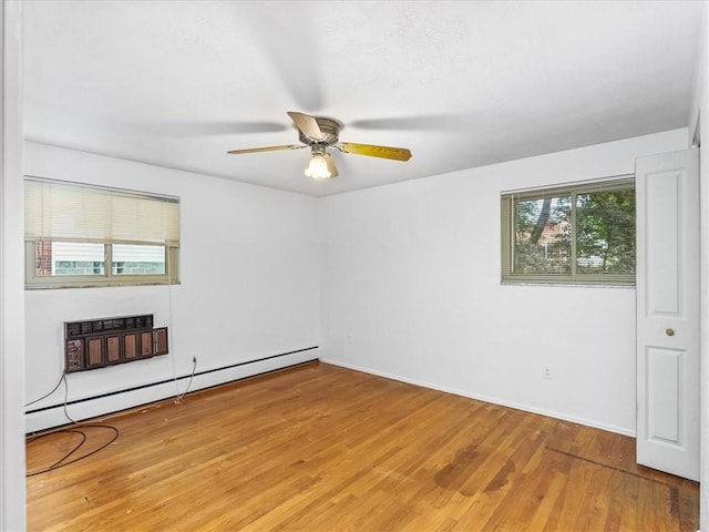 119 Abington Dr, Mt Lebanon, PA 15216 - spare room with baseboard heating, wood finished floors, a fireplace, and ceiling fan