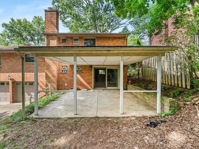 119 Abington Dr, Mt Lebanon, PA 15216 - rear view of house with a chimney, brick siding, and a patio area