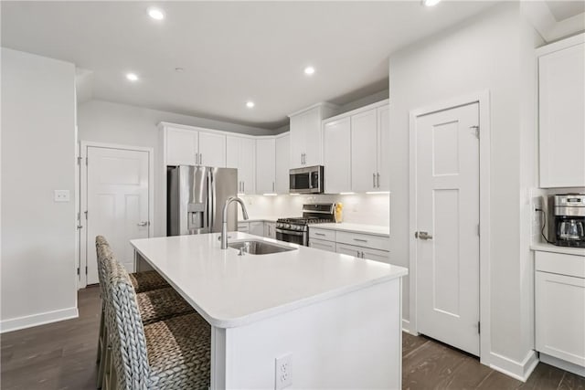 306 Helenium Dr, Adams Twp, PA 16046 - kitchen featuring appliances with stainless steel finishes, recessed lighting, a center island with sink, dark wood finished floors, and a breakfast bar