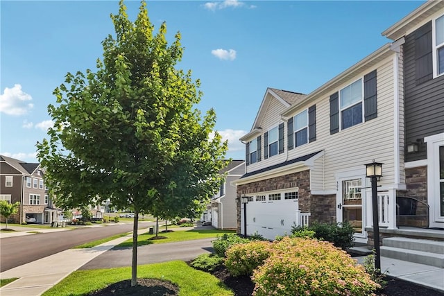 306 Helenium Dr, Adams Twp, PA 16046 - view of home's exterior featuring an attached garage, stone siding, a residential view, and driveway
