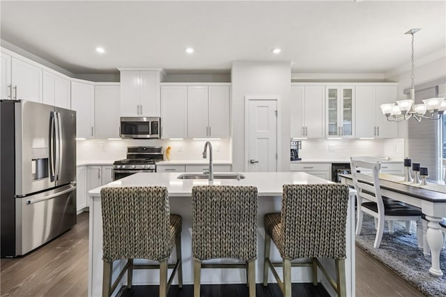 306 Helenium Dr, Adams Twp, PA 16046 - kitchen featuring appliances with stainless steel finishes, a chandelier, light countertops, dark wood-style flooring, and decorative backsplash