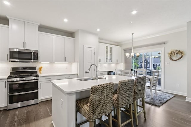 306 Helenium Dr, Adams Twp, PA 16046 - kitchen with stainless steel appliances, tasteful backsplash, light countertops, dark wood-type flooring, and white cabinetry