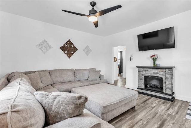 203 Stoney Hollow Rd, Winfield Twp, PA 16023 - living area with ceiling fan, wood finished floors, and a stone fireplace