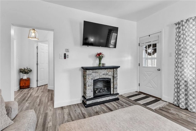 203 Stoney Hollow Rd, Winfield Twp, PA 16023 - living room with wood finished floors and a stone fireplace