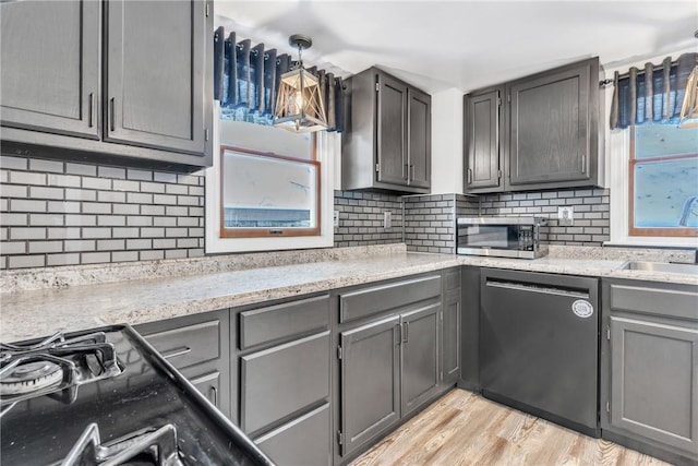203 Stoney Hollow Rd, Winfield Twp, PA 16023 - kitchen with dishwashing machine, stainless steel microwave, gray cabinets, and decorative backsplash