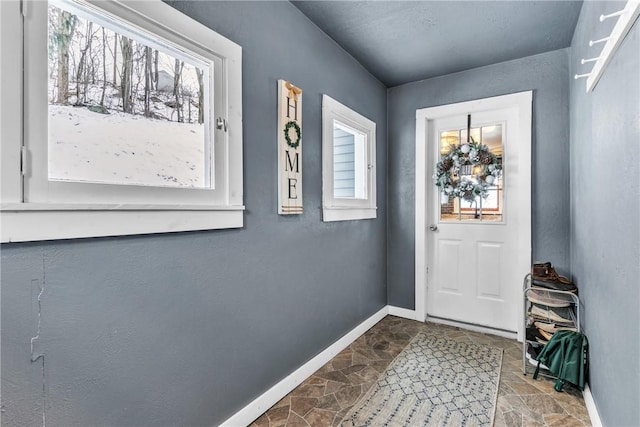 203 Stoney Hollow Rd, Winfield Twp, PA 16023 - entryway featuring dark stone finish floors and healthy amount of natural light