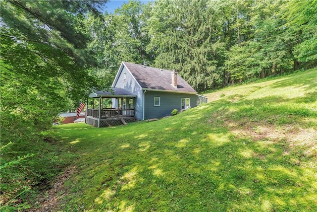 203 Stoney Hollow Rd, Winfield Twp, PA 16023 - view of side of property with a deck, a yard, a forest view, and a chimney