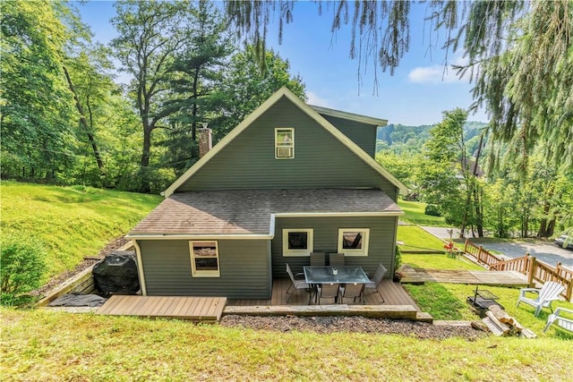203 Stoney Hollow Rd, Winfield Twp, PA 16023 - back of property with a wooden deck, a yard, roof with shingles, a chimney, and outdoor dining area