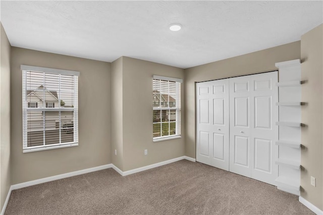 115 Cottonwood Dr, Brighton Twp, PA 15009 - unfurnished bedroom with carpet flooring, multiple windows, and a closet