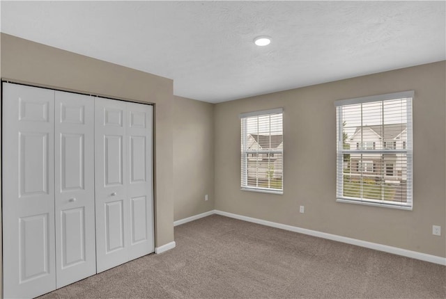 115 Cottonwood Dr, Brighton Twp, PA 15009 - unfurnished bedroom featuring carpet flooring, a closet, and a textured ceiling