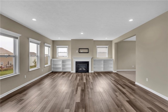 115 Cottonwood Dr, Brighton Twp, PA 15009 - unfurnished living room with wood finished floors, a glass covered fireplace, and recessed lighting