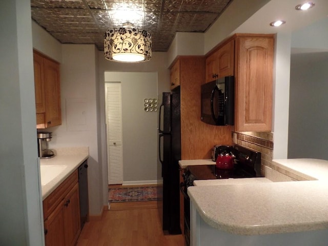2160 Greentree Rd Unit 701W, Pittsburgh, PA 15220 - kitchen with black appliances, an ornate ceiling, light wood-style floors, and light countertops