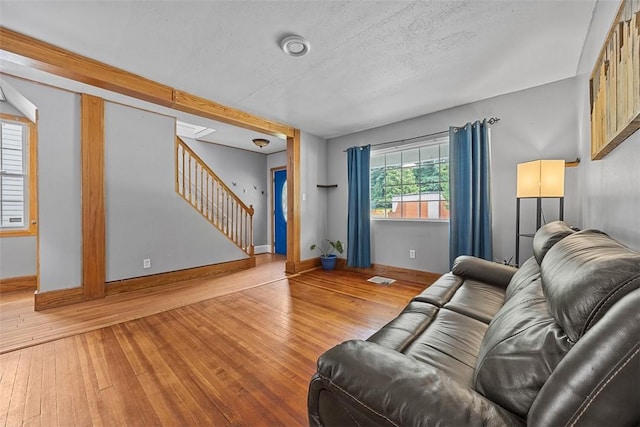 107 Ambridge Ave, Leet Twp, PA 15003 - living room featuring stairs, hardwood / wood-style flooring, and a textured ceiling