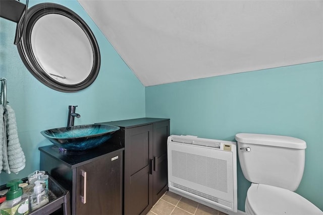 107 Ambridge Ave, Leet Twp, PA 15003 - bathroom featuring vaulted ceiling, heating unit, vanity, and tile patterned floors