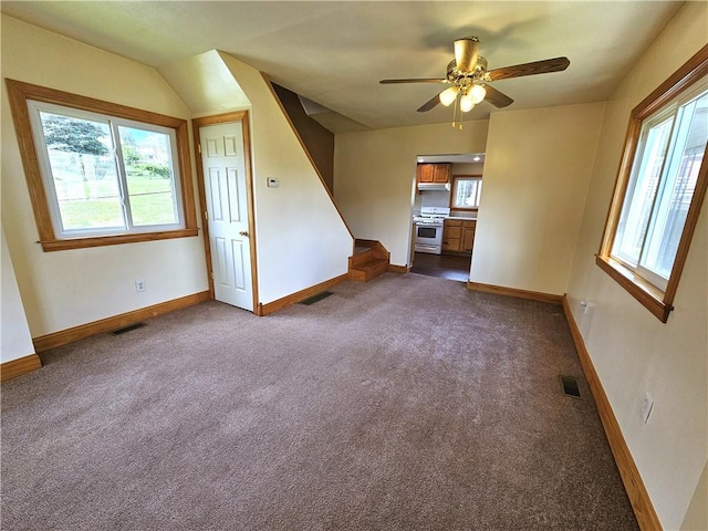 596 Beech St, City Of Washington, PA 15301 - unfurnished living room featuring dark colored carpet, healthy amount of natural light, and a ceiling fan