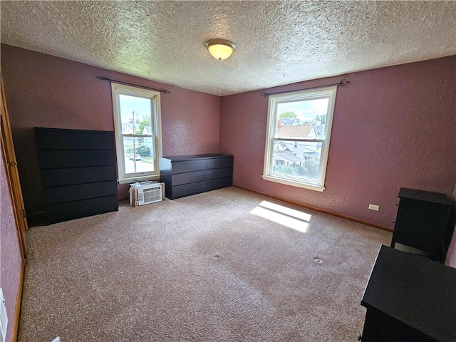 596 Beech St, City Of Washington, PA 15301 - unfurnished bedroom featuring a textured wall, a textured ceiling, carpet floors, and a wall unit AC