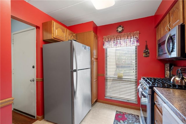 2034 Swallow Hill Rd Unit 419, Pittsburgh, PA 15220 - kitchen with stainless steel appliances, dark countertops, and brown cabinetry