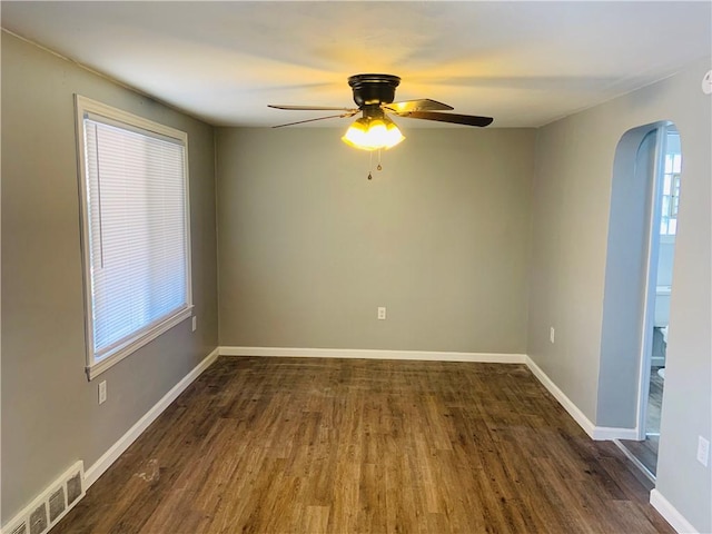 120 Graham Ave N, Versailles, PA 15137 - empty room featuring arched walkways, dark wood-type flooring, and ceiling fan