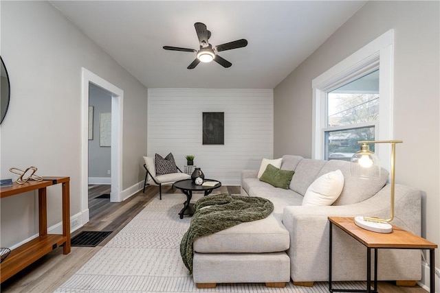 1122 Wade St, Aliquippa, PA 15001 - living area featuring ceiling fan, wood finished floors, and an accent wall