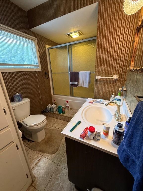3067 N 3rd St, Jamestown, PA 16134 - full bath featuring bath / shower combo with glass door, vanity, and tile patterned flooring