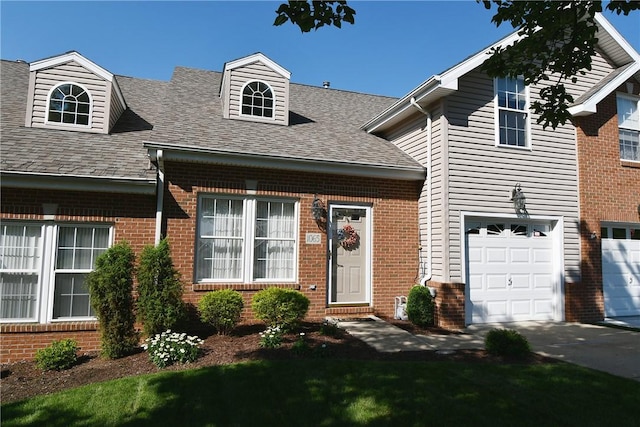 1065 Duncan Ln, Whitehall, PA 15236 - cape cod home with brick siding, a shingled roof, a garage, and driveway