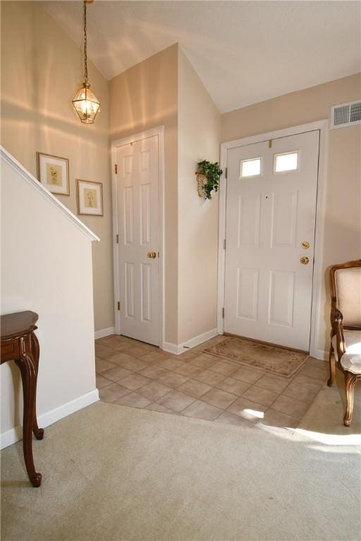 1065 Duncan Ln, Whitehall, PA 15236 - entryway with light colored carpet, lofted ceiling, and light tile patterned floors