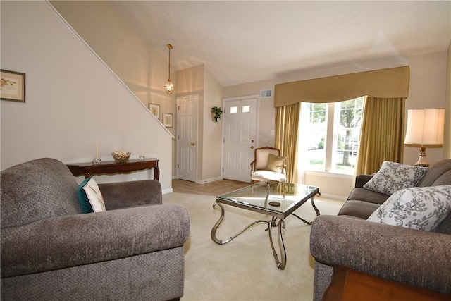 1065 Duncan Ln, Whitehall, PA 15236 - living area with carpet, stairs, and vaulted ceiling