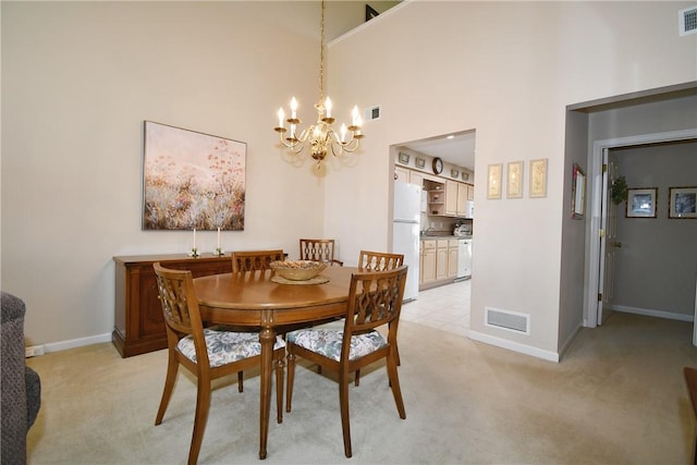 1065 Duncan Ln, Whitehall, PA 15236 - dining room featuring a chandelier, light colored carpet, and a high ceiling
