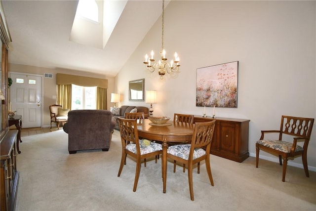 1065 Duncan Ln, Whitehall, PA 15236 - dining room featuring a chandelier, light colored carpet, high vaulted ceiling, and a skylight
