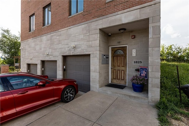 1825 Arcena St Unit 3, Downtown Pgh, PA 15219 - doorway to property with stone siding and an attached garage