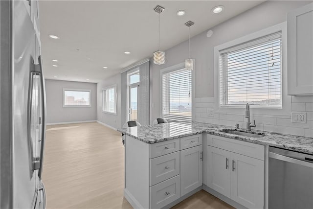 1825 Arcena St Unit 3, Downtown Pgh, PA 15219 - kitchen with appliances with stainless steel finishes, a peninsula, light wood-style floors, backsplash, and recessed lighting