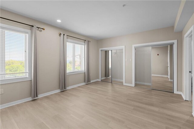 1825 Arcena St Unit 3, Downtown Pgh, PA 15219 - unfurnished bedroom featuring multiple closets, light wood-style floors, and recessed lighting