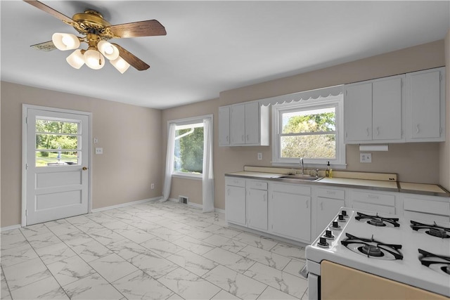108 Dave St, Daugherty Twp, PA 15066 - kitchen featuring white gas range oven, light marble finish flooring, plenty of natural light, and light countertops