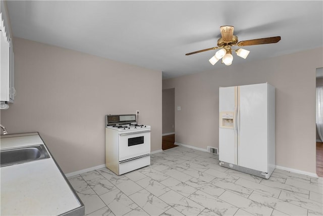 108 Dave St, Daugherty Twp, PA 15066 - kitchen with white appliances, light marble finish flooring, ceiling fan, and light countertops