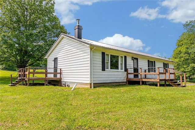 304 Wirsing Rd, Wharton Twp, PA 15440 - rear view of property with a deck, a chimney, a yard, and a metal roof