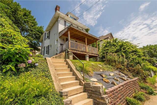 1246 Clairhaven St, Crafton Heights, PA 15205 - back of property featuring stairway, a chimney, and a wooden deck