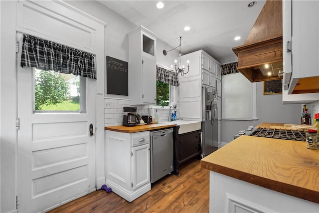 1246 Clairhaven St, Crafton Heights, PA 15205 - kitchen featuring stainless steel appliances, white cabinetry, dark wood finished floors, decorative backsplash, and a chandelier