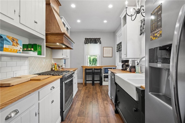 1246 Clairhaven St, Crafton Heights, PA 15205 - kitchen with appliances with stainless steel finishes, premium range hood, white cabinets, and recessed lighting