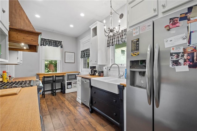 1246 Clairhaven St, Crafton Heights, PA 15205 - kitchen featuring stainless steel appliances, a chandelier, dark wood-style flooring, decorative backsplash, and recessed lighting