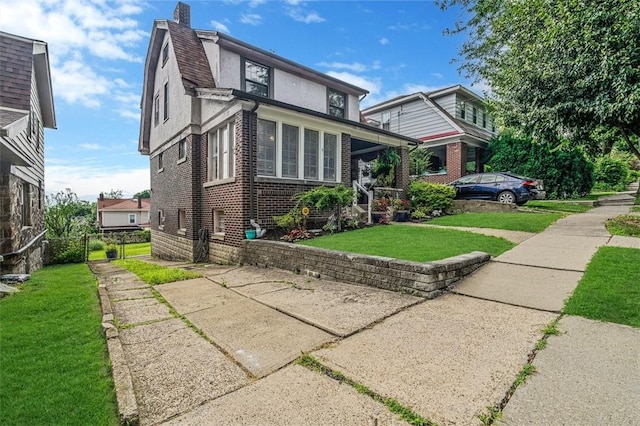 432 Kenmont Ave, Mt Lebanon, PA 15228 - view of front of property with brick siding, a front yard, stucco siding, driveway, and a chimney